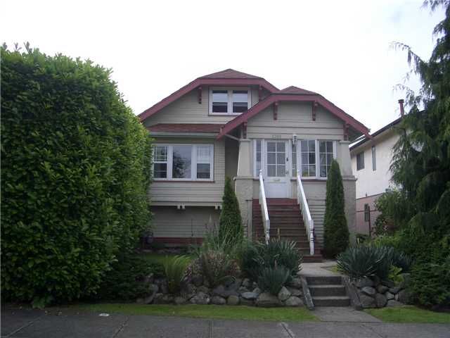 2356 Grant Street before renovation — original facade with red trim, overgrown hedge and open front steps
